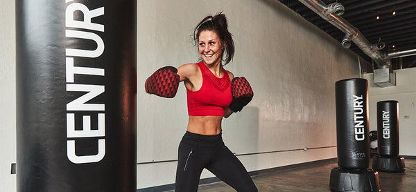 Woman training in red gloves hitting a bag