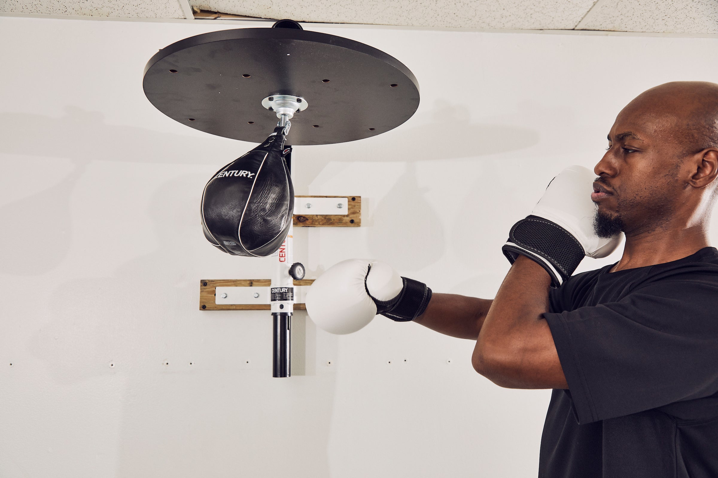 man in gloves training on speed bag