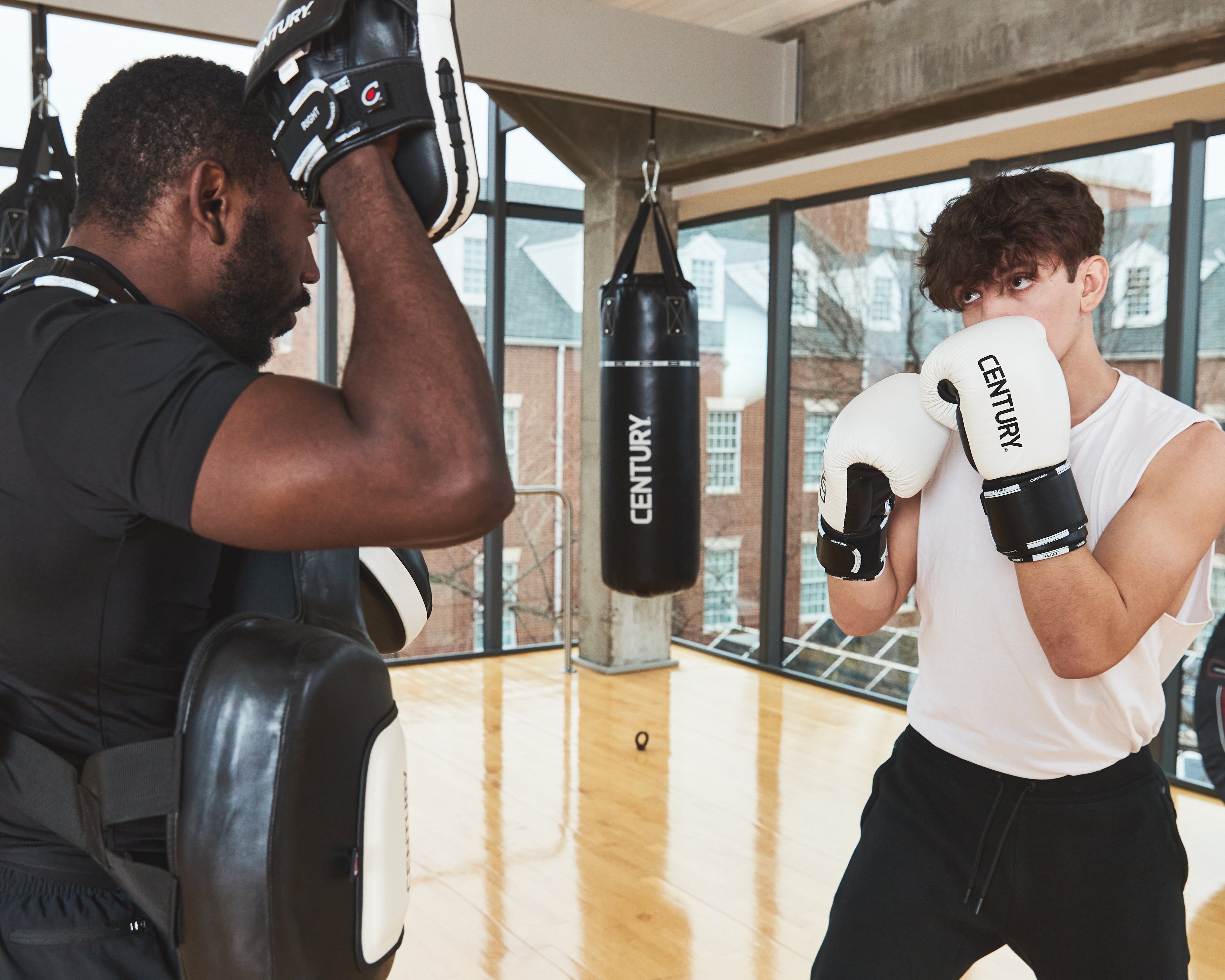 Men wearing gloves training in gym