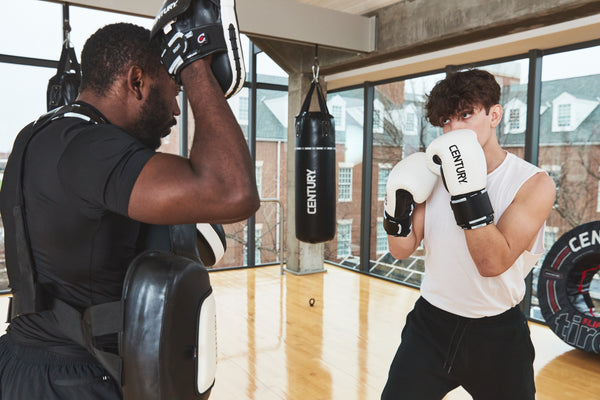 Men wearing gloves training in gym