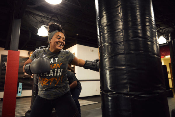 Woman in kickboxing class hitting bag