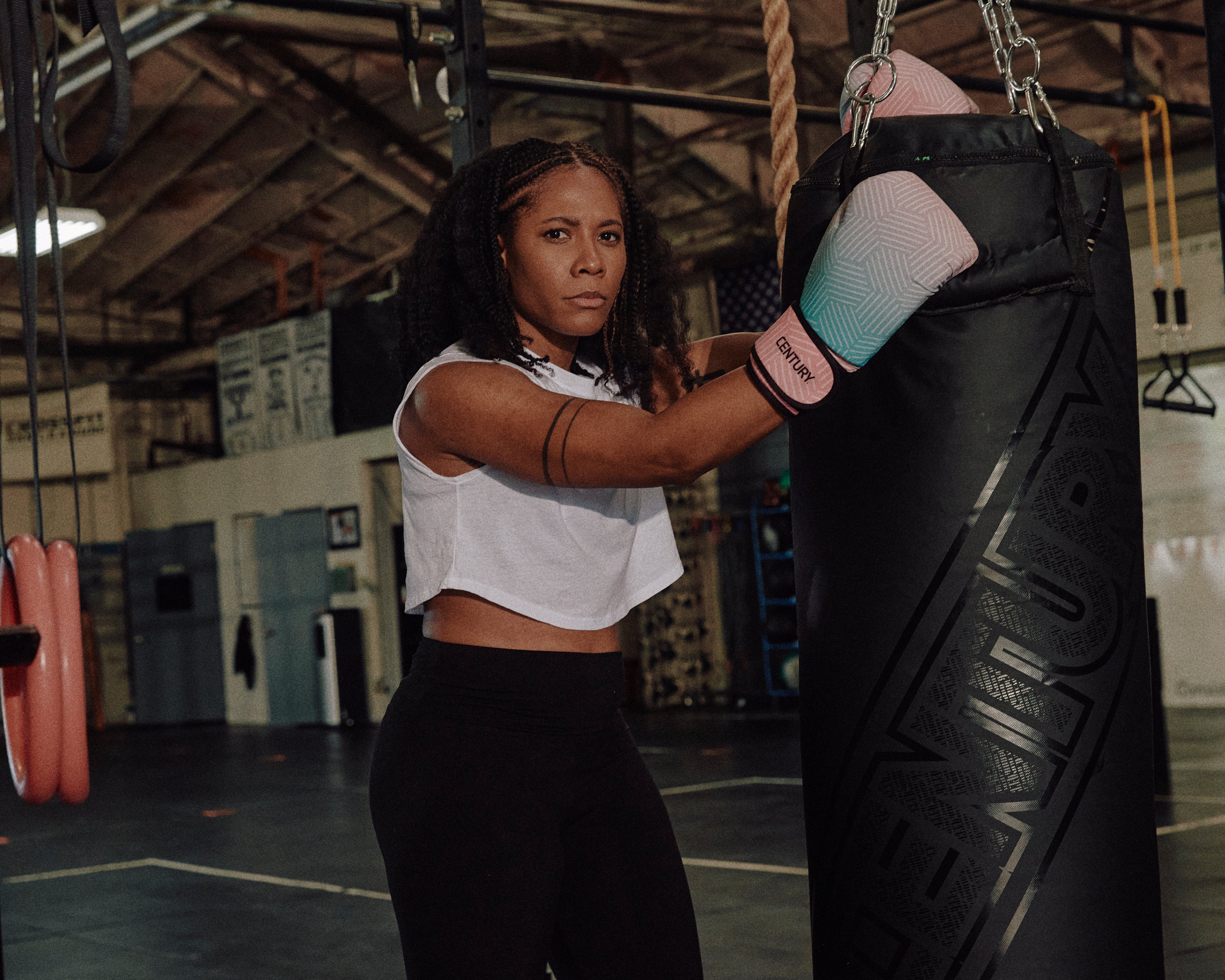 Woman wearing gloves posing with hanging bag