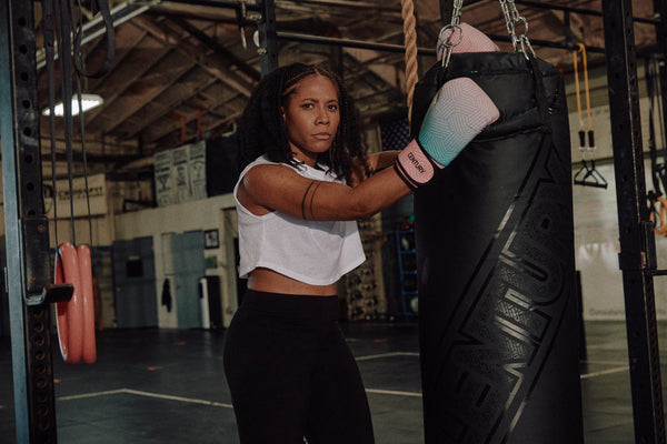 Woman wearing gloves posing with hanging bag