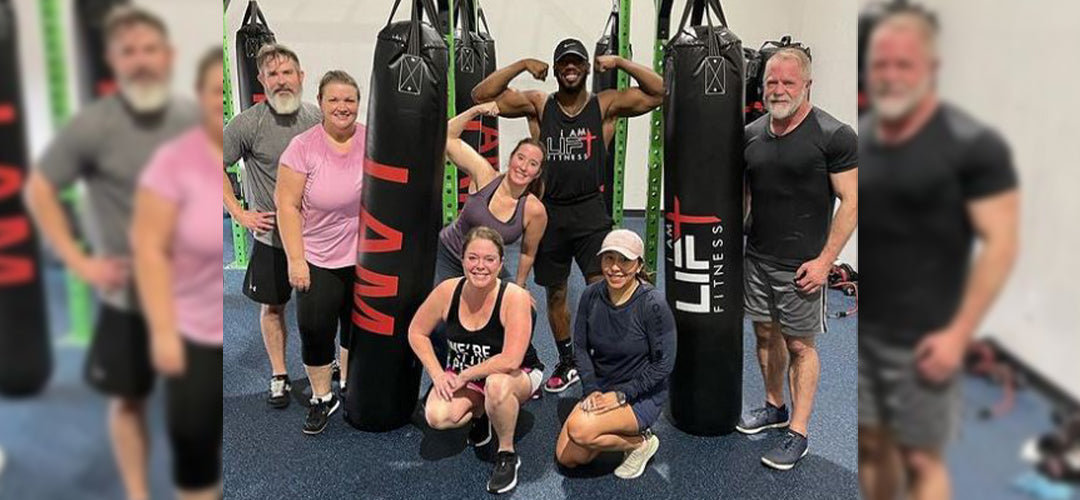 People posing in gym with custom hanging bags
