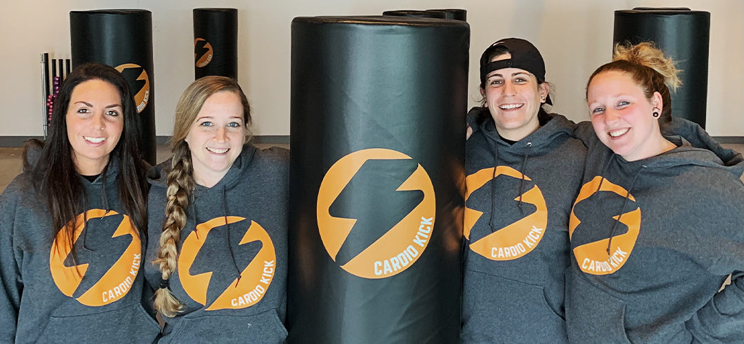 Women in custom t-shirts posing with custom freestanding bag