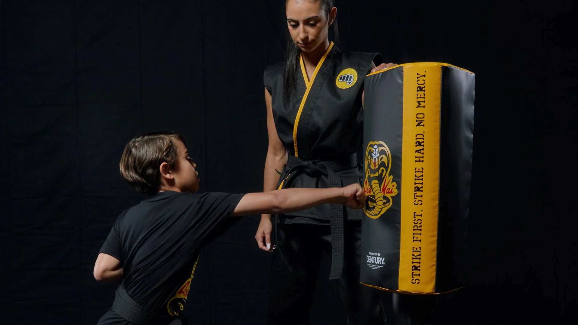 instructor and student using century's cobra kai wavemaster freestanding bag