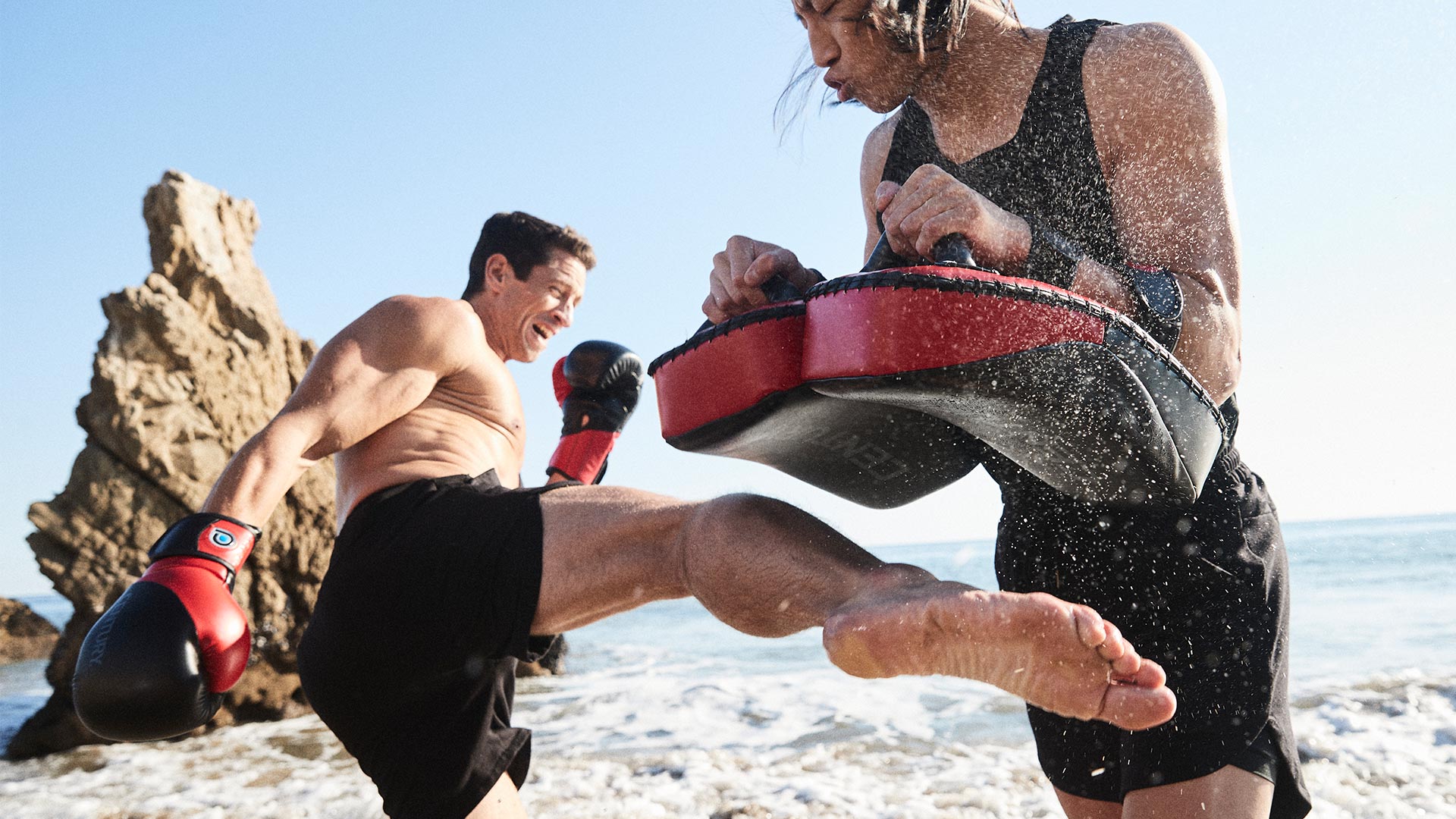 men sparring using century's drive muay thai pads and boxing gloves