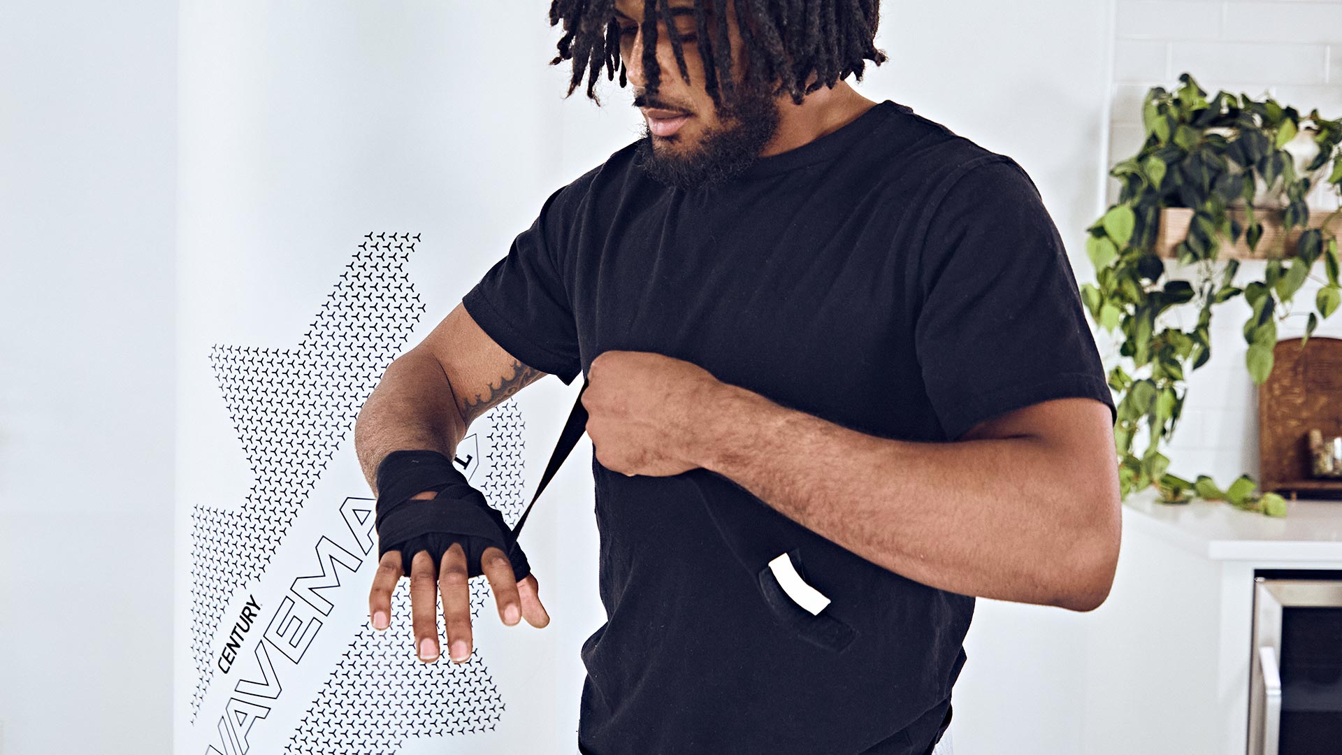 man wrapping his hands in century handwraps