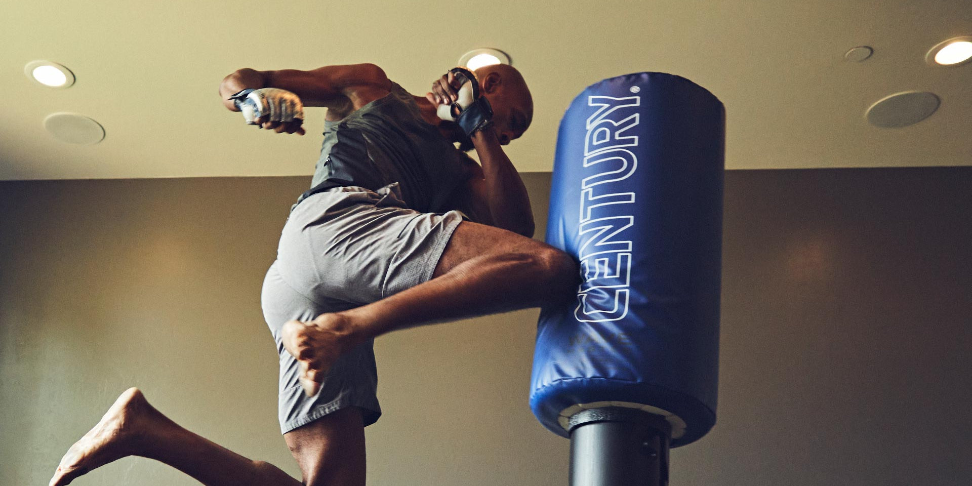 man kicking century kickboxing bag wavemaster original