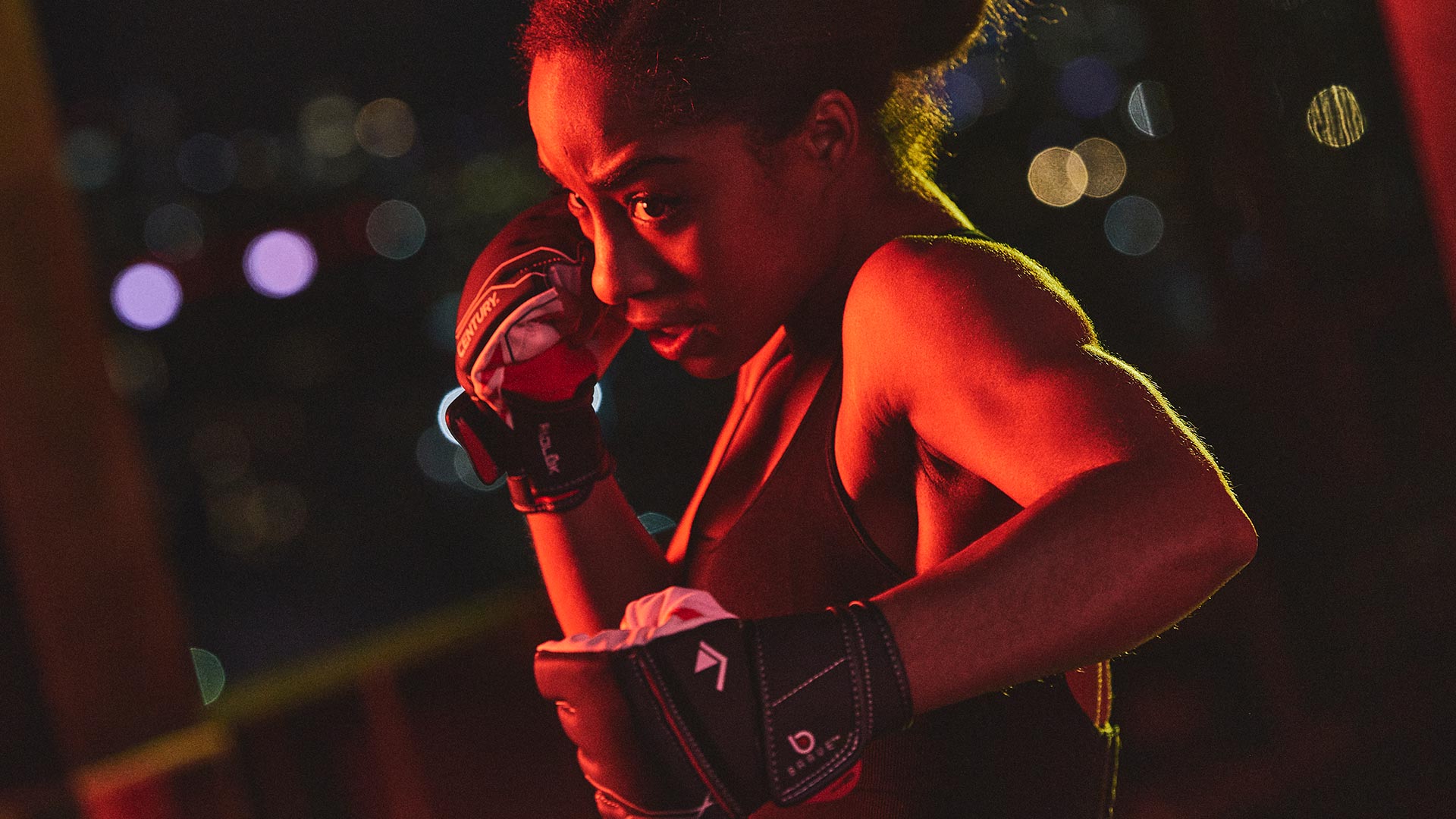 woman posed wearing century's brave mixed martial arts gloves
