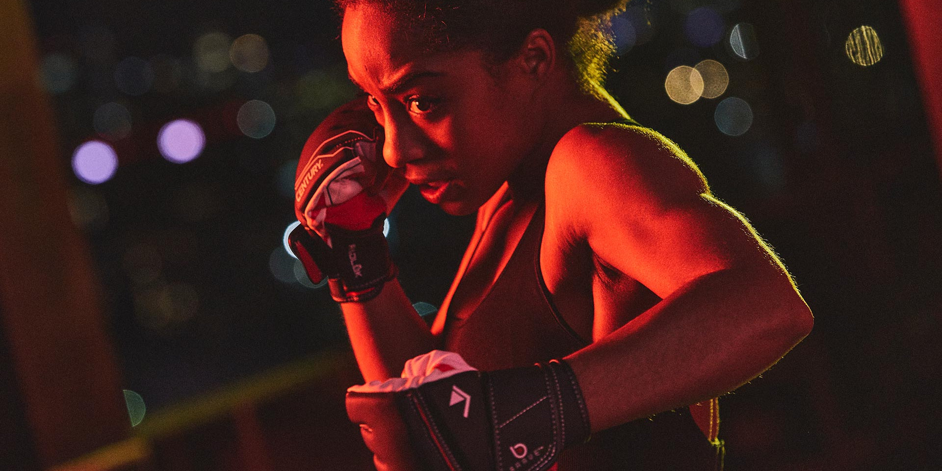 woman posed wearing century's brave mixed martial arts gloves