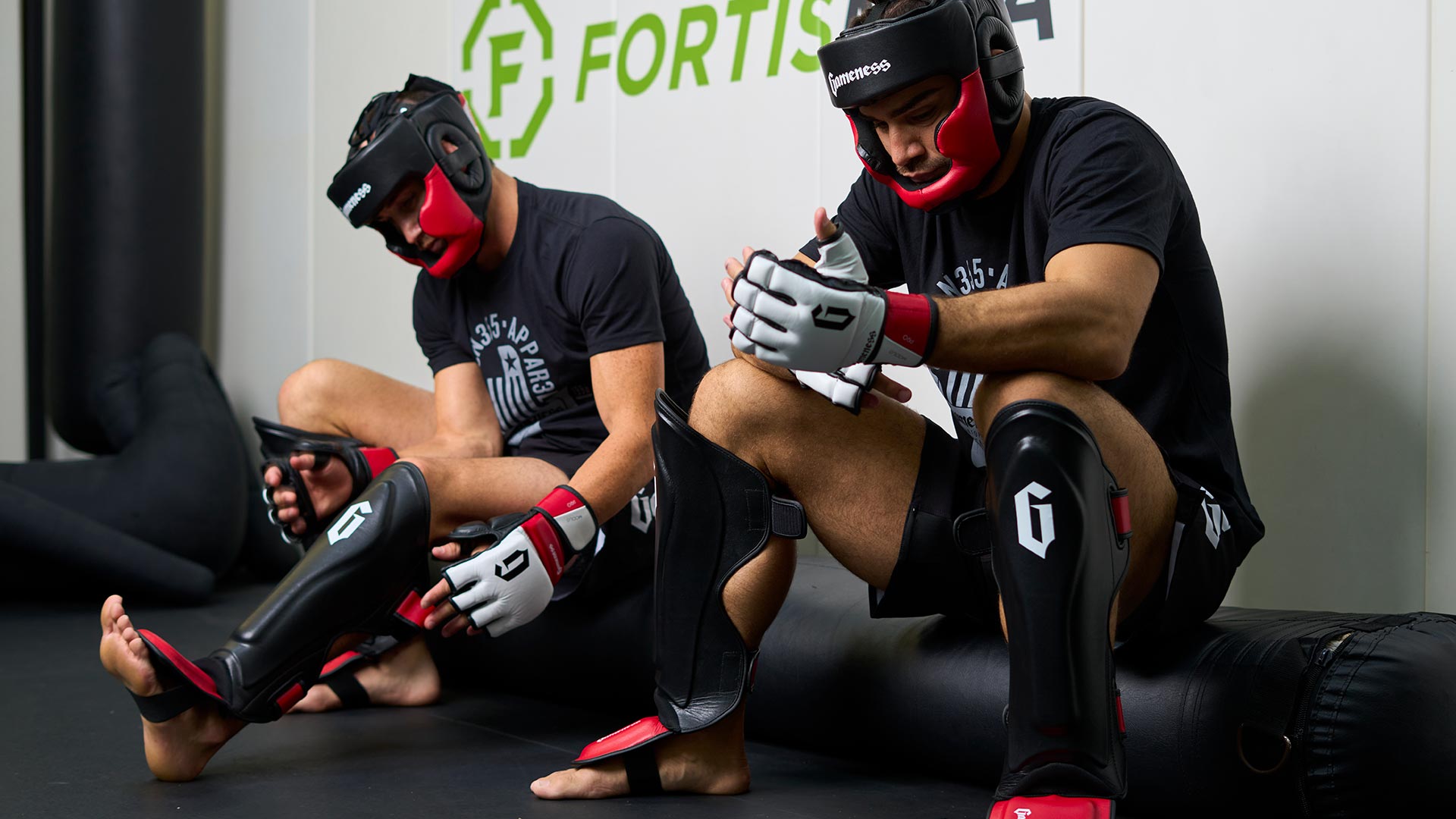 men wearing century's modus pro gear, shin guards, mma gloves, and helmets