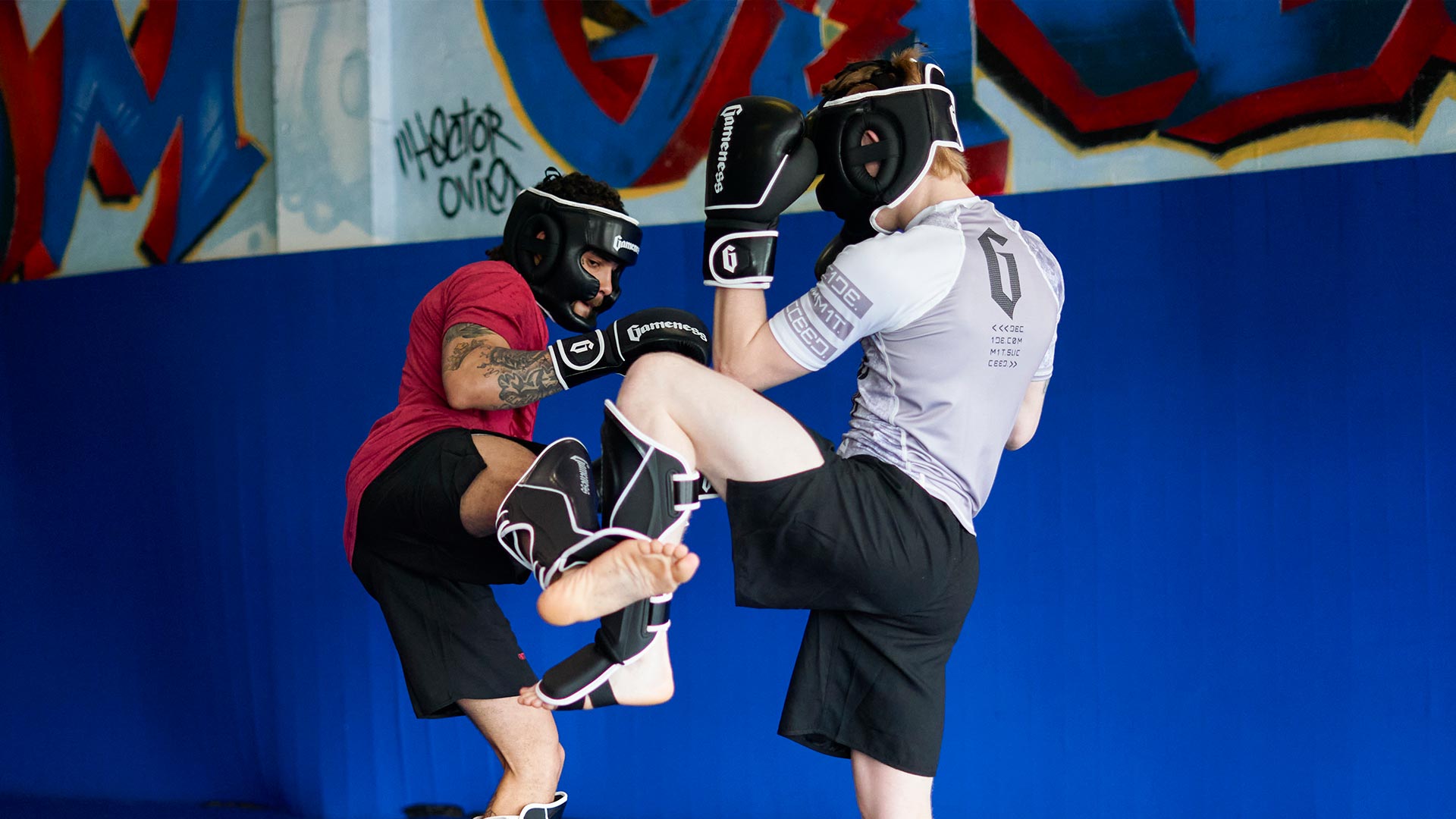 two men sparring in century's rukus headgear, gloves and shinguards