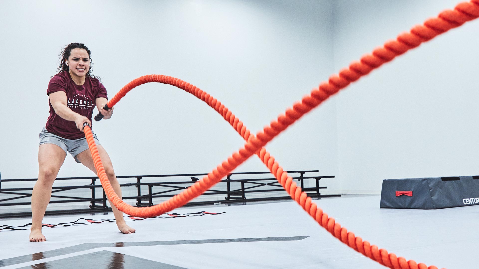 woman using century challenge rope in fitness room