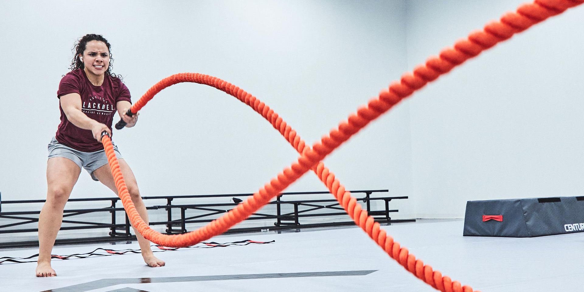 woman using century challenge rope in fitness room