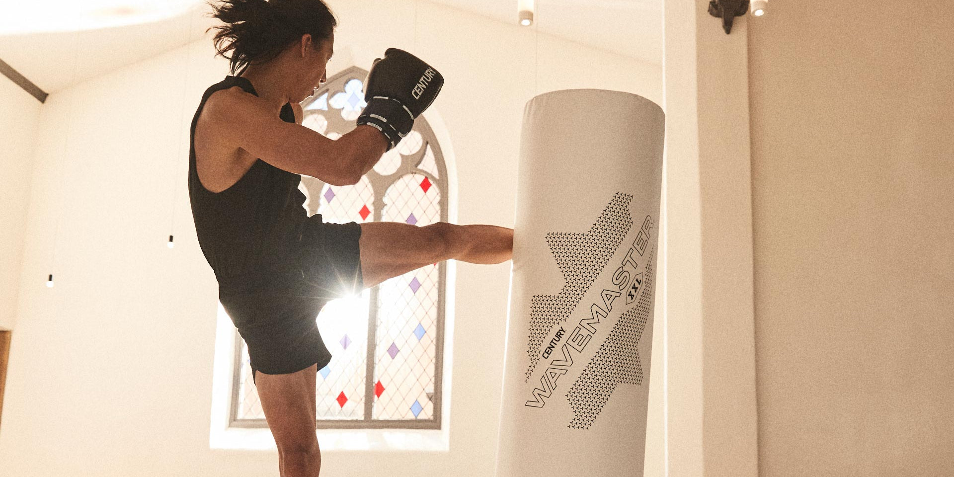 man kicking xxl ghost wavemaster freestanding bag wearing century boxinggloves