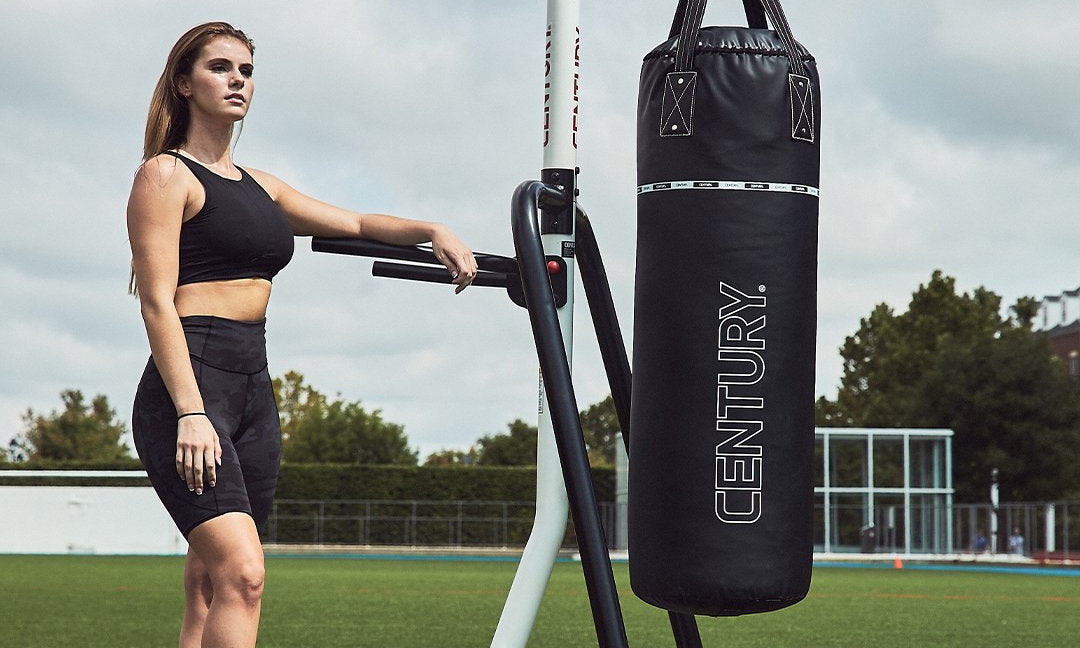 Woman posing with hanging bag stand