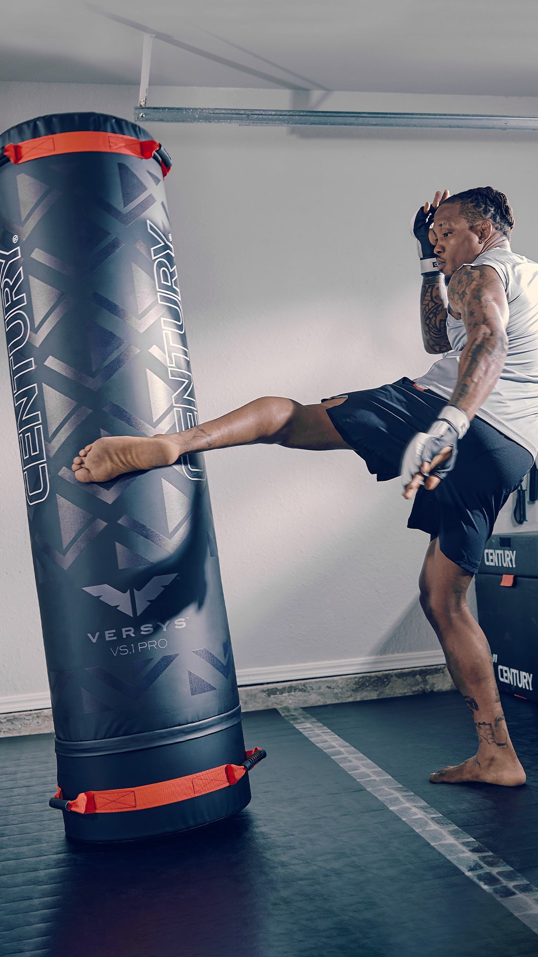 man kicking freestanding punching bag