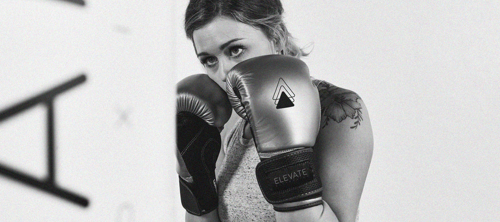 Girl in gloves hitting bag