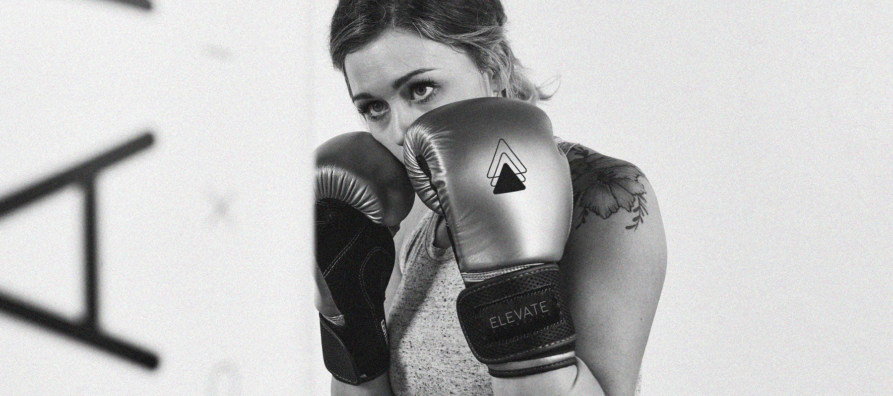 Girl in gloves hitting bag
